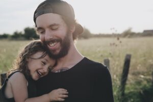 father hugs daughter