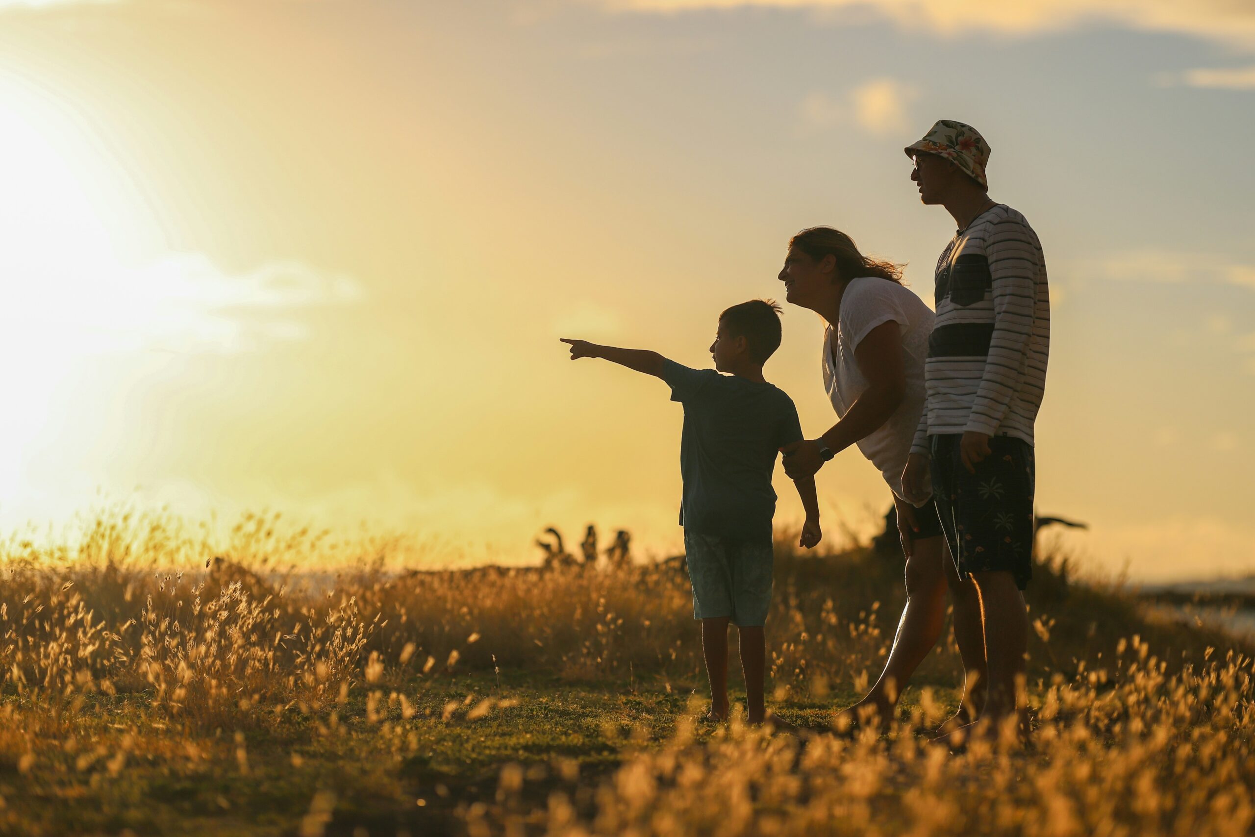 family outside in nature at sunset